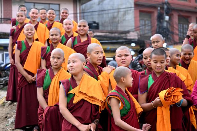 Novice Buddhist monks look on as they visit the Swayambhunath Stupa during Buddha Purnima commemorating Buddha's birthday, in Kathmandu on May 1, 2026. (Photo by PRAKASH MATHEMA / AFP)