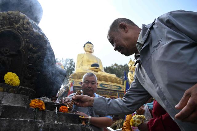 Buddhist devotees light incense sticks at the Swayambhunath Stupa during Buddha Purnima commemorating Buddha's birthday, in Kathmandu on May 1, 2026. (Photo by PRAKASH MATHEMA / AFP)