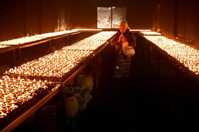 A Buddhist devotee offers prayers at the Swayambhunath Stupa during Buddha Purnima commemorating Buddha's birthday, in Kathmandu on May 1, 2026. (Photo by PRAKASH MATHEMA / AFP)