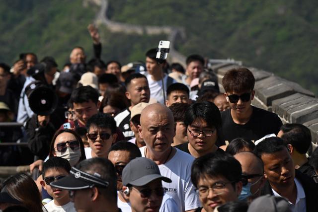 People climb the Great Wall of China at Badaling, north of Beijing, on May 1, 2026, on the first day of a five-day national May Day holiday. (Photo by GREG BAKER / AFP)
