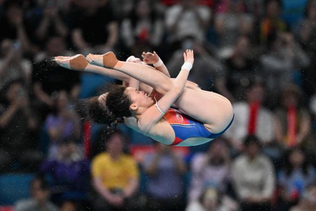 Chen Yuxi (front) and Lu Wei (back) compete in the women’s 10m synchronised diving at the World Aquatics Diving World Cup Super Finals 2026 in Beijing on May 1, 2026. (Photo by ADEK BERRY / AFP)