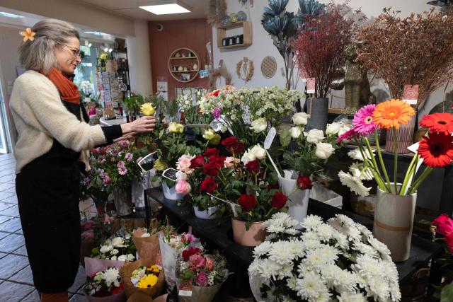 An employee is at work in a flower shop in Quimper, western France, on May 1, 2026. The debate over whether independent bakers, florists and other small traders should be allowed to employ staff on May 1 has taken on a national dimension in recent weeks, with the government indicating that bakers and florists may open with their staff as of this year, before a bill formalises the arrangement from next year. (Photo by Fred TANNEAU / AFP)