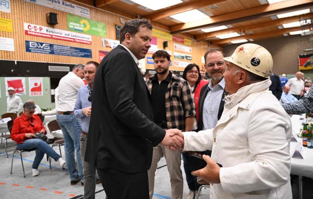 Chairman of the Germany's Social Democratic Party (SPD) and Vice-Chancellor Lars Klingbeil shakes hands as he arrives for a May Day demonstration with the motto "together for good work" of trade union IGBCE (IG Mining, Chemistry, Energy) in Bergkamen, on May 1, 2026. (Photo by INA FASSBENDER / AFP)