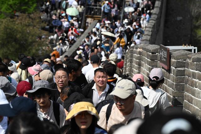 People climb the Great Wall of China at Badaling, north of Beijing, on May 1, 2026, on the first day of a five-day national May Day holiday. (Photo by Greg Baker / AFP)