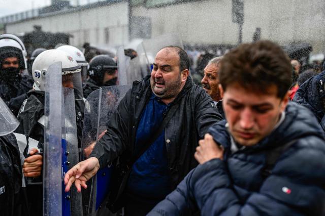 A protestor reacts as Turkish police use pepper spray to disperse demonstrators during a May Day (Labour Day) rally, marking international Workers' Day, in Besiktas, a district of Istanbul, on May 1, 2026. Turkish police fired tear gas and arrested dozens of people holding May Day demonstrations in Istanbul, AFP journalists said. Two groups were specially singled out in the city's European side after signalling their intention to march to Taksim square -- the scene of several anti-government protests in the past -- which was sealed off overnight by police. (Photo by Yasin AKGUL / AFP)