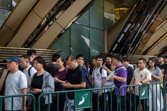 Visitors queue outside the Grand Lisboa hotel resort during the Labour Day holiday in Macau on May 1, 2026. (Photo by Eduardo Leal / AFP)
