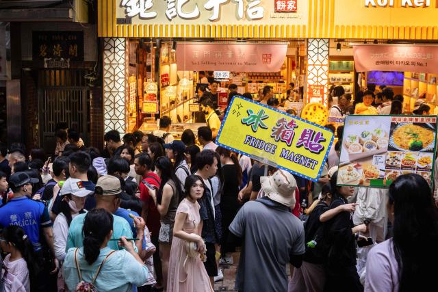 Visitors walk at the historical centre during the Labour Day holiday in Macau on May 1, 2026. (Photo by Eduardo Leal / AFP)
