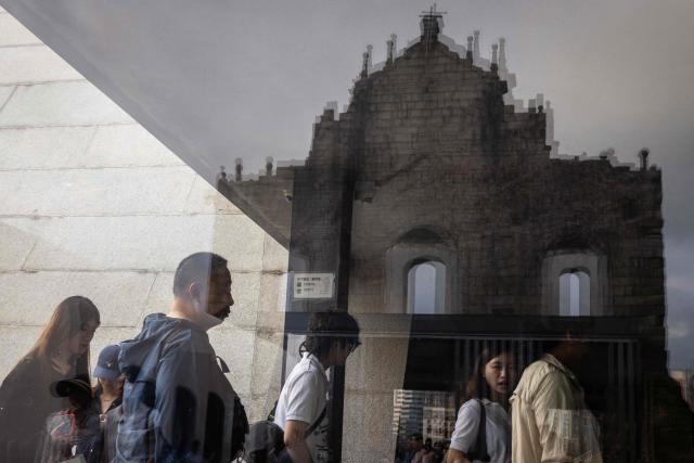 Visitors enter the crypt of the Ruins of Saint Paul's during the Labour Day holiday in Macau on May 1, 2026. (Photo by Eduardo Leal / AFP)