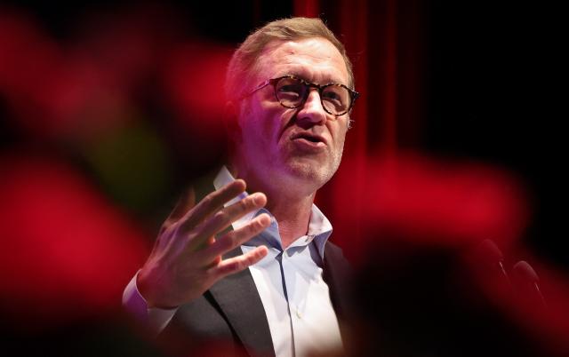President of the Belgian Socialist Party, Paul Magnette, gestures as he speaks during a meeting marking May Day (Labour Day), International Workers' Day, in Charleroi on May 1, 2026. (Photo by VIRGINIE LEFOUR / Belga / AFP) / Belgium OUT