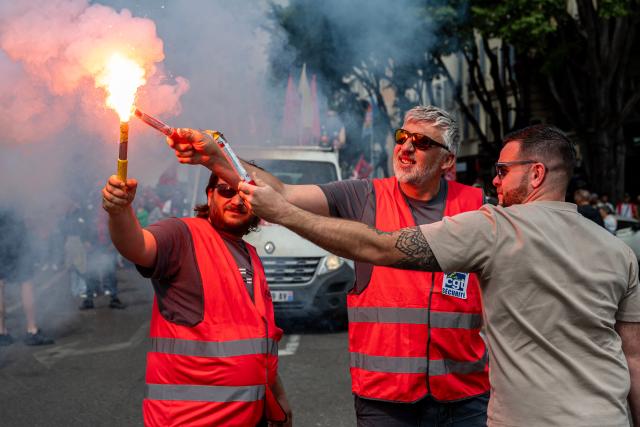 Demonstrators light flares during a May Day rally marking International Workers' Day in Marseille, on May 1, 2026. (Photo by MIGUEL MEDINA / AFP)