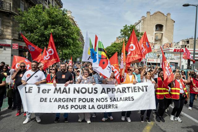Members of French trade union General Confederation of Labour (CGT) hold a placard reading "May 1 belongs to us. Money for our wages, not for war" during a May Day rally marking International Workers' Day in Marseille, on May 1, 2026. (Photo by MIGUEL MEDINA / AFP)
