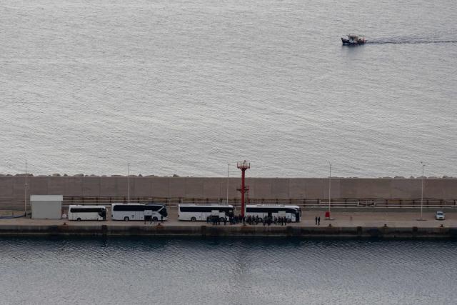 Activists from the Global Sumud Flotilla stand at the port of Atherinolakkos on the island of Crete after disembarking from a Greek Coast Guard vessel, following their interception by the Israeli Navy in international waters, on May 1, 2026. (Photo by Eleftherios Elis MITZA / AFP)