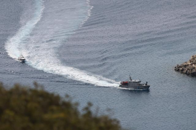 A Greek Coast Guard vessel carrying activists from the Global Sumud Flotilla, which had been intercepted by the Israeli Navy in international waters, arrives at the port of Atherinolakkos on the island of Crete, on May 1, 2026. (Photo by Costas METAXAKIS / AFP)
