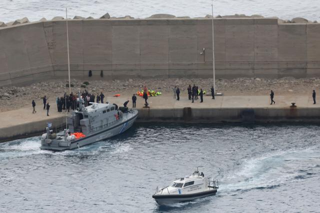 Activists from the Global Sumud Flotilla stand at the port of Atherinolakkos on the island of Crete after disembarking from a Greek Coast Guard vessel, following their interception by the Israeli Navy in international waters, on May 1, 2026. (Photo by Costas METAXAKIS / AFP)