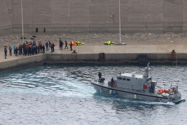 Activists from the Global Sumud Flotilla stand at the port of Atherinolakkos on the island of Crete after disembarking from a Greek Coast Guard vessel, following their interception by the Israeli Navy in international waters, on May 1, 2026. (Photo by Costas METAXAKIS / AFP)