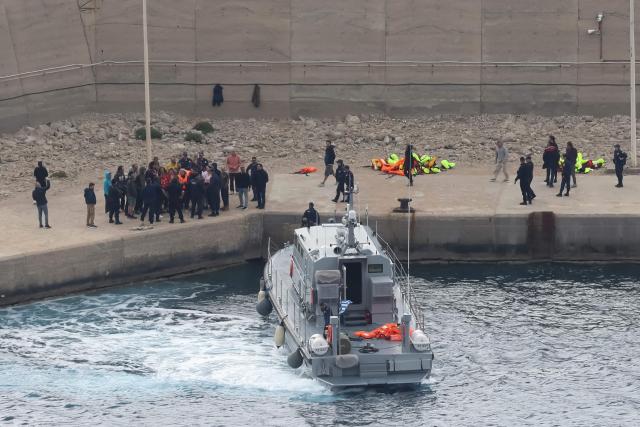 Activists from the Global Sumud Flotilla stand at the port of Atherinolakkos on the island of Crete after disembarking from a Greek Coast Guard vessel, following their interception by the Israeli Navy in international waters, on May 1, 2026. (Photo by Costas METAXAKIS / AFP)