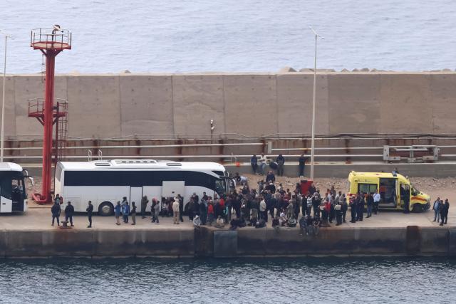 Activists from the Global Sumud Flotilla stand at the port of Atherinolakkos on the island of Crete after disembarking from a Greek Coast Guard vessel, following their interception by the Israeli Navy in international waters, on May 1, 2026. (Photo by Costas METAXAKIS / AFP)