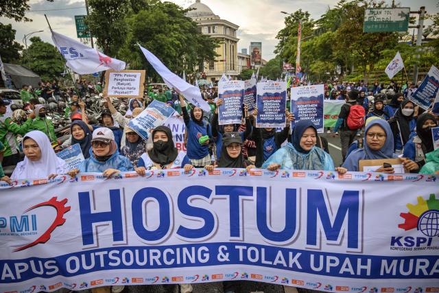 Indonesian workers take part in a demonstration during a May Day rally marking International Workers' Day in front of the East Java Governor’s Office in Surabaya on May 1, 2026. (Photo by JUNI KRISWANTO / AFP)