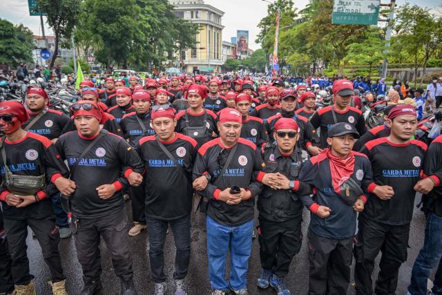 Indonesian workers take part in a demonstration during a May Day rally marking International Workers' Day in front of the East Java Governor’s Office in Surabaya on May 1, 2026. (Photo by JUNI KRISWANTO / AFP)