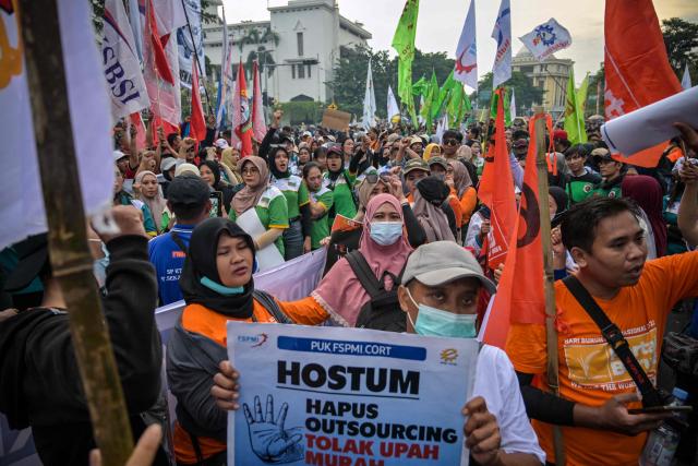 Indonesian workers take part in a demonstration during a May Day rally marking International Workers' Day in front of the East Java Governor’s Office in Surabaya on May 1, 2026. (Photo by JUNI KRISWANTO / AFP)