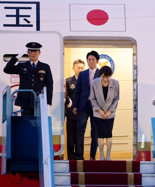 Japan's Prime Minister Sanae Takaichi (R) bows as she disembarks a plane upon her arrival at Noi Bai International Airport in Hanoi on May 1, 2026. (Photo by Hoang Long / AFP)