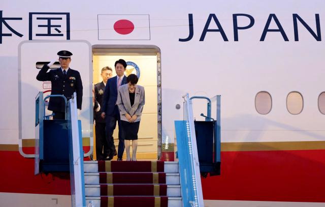 Japan's Prime Minister Sanae Takaichi (R) bows as she disembarks a plane upon her arrival at Noi Bai International Airport in Hanoi on May 1, 2026. (Photo by Hoang Long / AFP)
