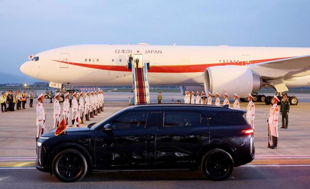 A vehicle transports Japan's Prime Minister Sanae Takaichi upon her arrival at Noi Bai International Airport in Hanoi on May 1, 2026. (Photo by Hoang Long / AFP)