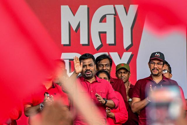 Sri Lanka's President and National People's Power (NPP) party leader Anura Kumara Dissanayake (C) greets his supporters during a rally to mark International Labour Day in Colombo on May 1, 2026. (Photo by Ishara S. KODIKARA / AFP)