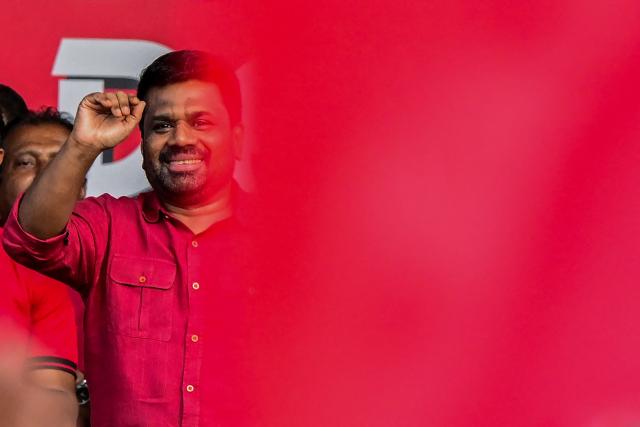 Sri Lanka's President and National People's Power (NPP) party leader Anura Kumara Dissanayake greets his supporters during a rally to mark International Labour Day in Colombo on May 1, 2026. (Photo by Ishara S. KODIKARA / AFP)