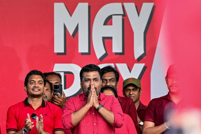Sri Lanka's President and National People's Power (NPP) party leader Anura Kumara Dissanayake (C) greets his supporters during a rally to mark International Labour Day in Colombo on May 1, 2026. (Photo by Ishara S. KODIKARA / AFP)