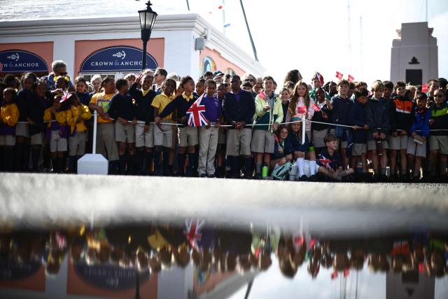 People arrive before Britain's King Charles III and Queen Camilla attend a ceremonial welcome at King's Square in St. George's, Bermuda, on May 1, 2026. King Charles III is in Bermuda for his first visit to a British Overseas Territory as Sovereign. (Photo by Henry NICHOLLS / POOL / AFP)