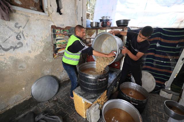 Food is prepared in a charity kitchen for displaced Palestinian families who lost their homes in the Israeli military strikes on the Gaza Strip, in the Bureij refugee camp, in central Gaza on May 1, 2026. The war on the Gaza Strip was sparked following the militant Palestinian group Hamas's October 7, 2023 attack on Israel, which resulted in the deaths of 1,221 people. Israel's retaliatory assault on Gaza has killed at least 72,600 people, according to figures from the health ministry that the UN considers reliable. with th  majority of Gaza's 2.4 million people being displaced. (Photo by Eyad Baba / AFP)