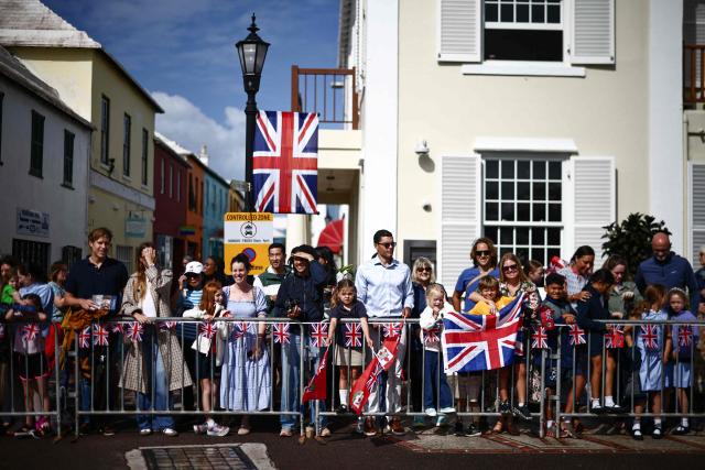 People arrive before Britain's King Charles III and Queen Camilla attend a ceremonial welcome at King's Square in St. George's, Bermuda, on May 1, 2026. King Charles III is in Bermuda for his first visit to a British Overseas Territory as Sovereign. (Photo by Henry NICHOLLS / POOL / AFP)