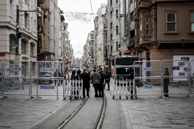 Police officers block Taksim square and Istiklal avenue using barriers during a May Day (Labour Day), marking International Workers' Day, in the Taksim district of Istanbul, on May 1, 2026. At least 370 people were arrested on May 1, 2026 during demonstrations in Istanbul curbed by a heavy police deployment, a lawyers' association present at the rallies said. (Photo by BERK OZKAN / AFP)