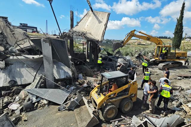 TOPSHOT - First responders search for survivors amongst the rubble at the site of an Israeli airstrike that targeted the southern Lebanese village of Ain Baal on May 1, 2026. Israeli airstrikes on southern Lebanon killed at least 17 people on April 30, 2026, the Health Ministry announced, despite the ceasefire that has been in effect since April 17. Lebanon was drawn into the Middle East war on March 2 when Tehran-backed militant group Hezbollah launched attacks on Israel to avenge the killing of the Iranian leader. Israel has responded with broad strikes across Lebanon and a ground offensive. (Photo by Kawnat HAJU / AFP)