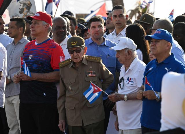 Cuba's President Miguel Diaz-Canel (2-L), former President Raul Castro (C) and former VicePpresident Jose Ramon Machado Ventura (2-R) attend a May Day rally marking International Workers’ Day in Havana on May 1, 2026. (Photo by YAMIL LAGE / AFP)