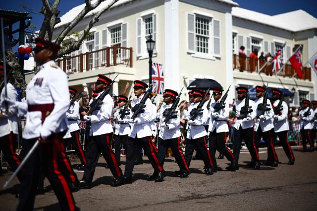 Members of the Royal Bermuda Regiment (RBR) prepare for an arrival ceremony for King Charles III and Queen Camilla during a ceremonial welcome at King's Square in St. George's, Bermuda, on May 1, 2026. King Charles III is in Bermuda for his first visit to a British Overseas Territory as Sovereign. (Photo by Henry NICHOLLS / POOL / AFP)