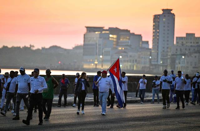 People march along Havana’s waterfront to mark International Workers’ Day at the Anti-Imperialist Platform in front of the US Embassy in Havana on May 1, 2026. (Photo by ADALBERTO ROQUE / AFP)