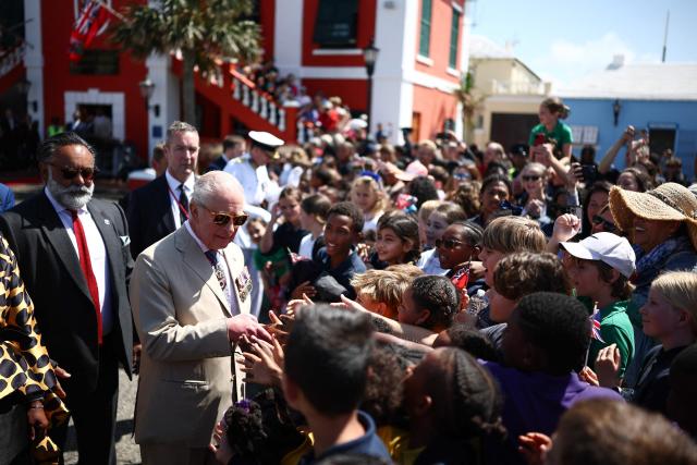 Britain's King Charles III greets members of the public during a ceremonial welcome at King's Square in St. George's, Bermuda, on May 1, 2026. King Charles III is in Bermuda for his first visit to a British Overseas Territory as Sovereign. (Photo by HENRY NICHOLLS / POOL / AFP)
