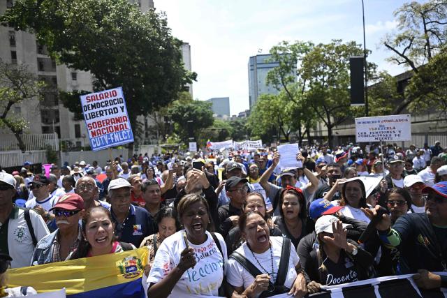 Demonstrators take part in a protest demanding better working conditions and pensions during a May Day rally marking International Workers Day, in Caracas, on May 1, 2026. (Photo by Federico PARRA / AFP)