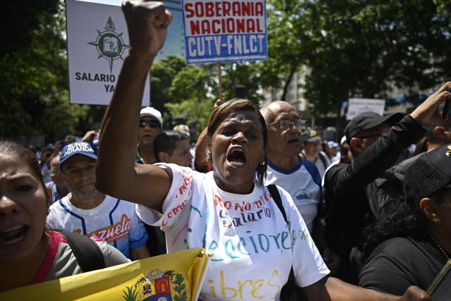 Demonstrators take part in a protest demanding better working conditions and pensions during a May Day rally marking International Workers Day, in Caracas, on May 1, 2026. (Photo by Federico PARRA / AFP)