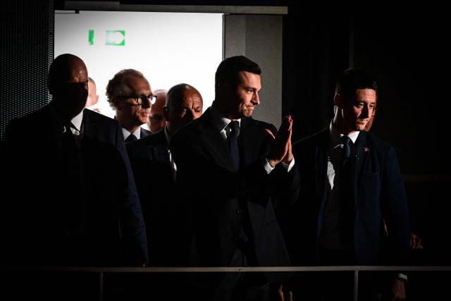French far-right party Rassemblement National (RN) president Jordan Bardella (C) arrives to deliver a speech during the "Fete de la nation" meeting in Macon on May 1, 2026. (Photo by OLIVIER CHASSIGNOLE / AFP)