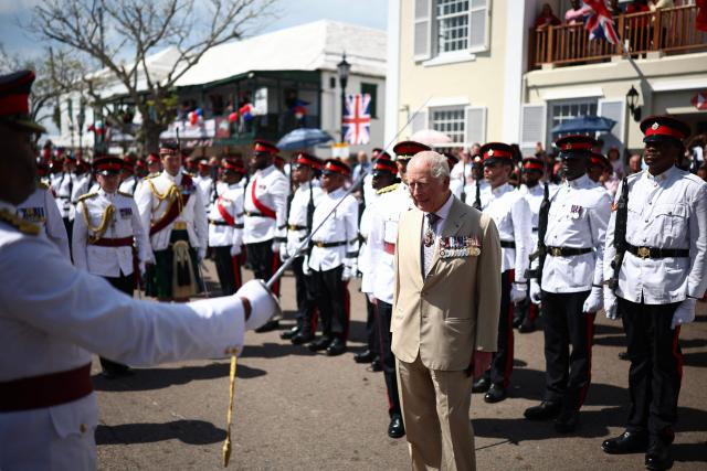 Britain's King Charles III reviews the troops during a ceremonial welcome at King's Square in St. George's, Bermuda, on May 1, 2026. King Charles III is in Bermuda for his first visit to a British Overseas Territory as Sovereign. (Photo by HENRY NICHOLLS / POOL / AFP)