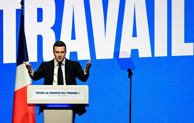 French far-right party Rassemblement National (RN) president Jordan Bardella gestures as he delivers a speech during the "Fete de la nation" meeting in Macon on May 1, 2026. (Photo by OLIVIER CHASSIGNOLE / AFP)