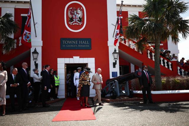 Britain's King Charles III departs the St. George's Bermuda Towne Hall joined by the Mayor of St. George Quinell Francis (L) during a ceremonial welcome at King's Square in St. George's, Bermuda, on May 1, 2026. King Charles III is in Bermuda for his first visit to a British Overseas Territory as Sovereign. (Photo by HENRY NICHOLLS / POOL / AFP)