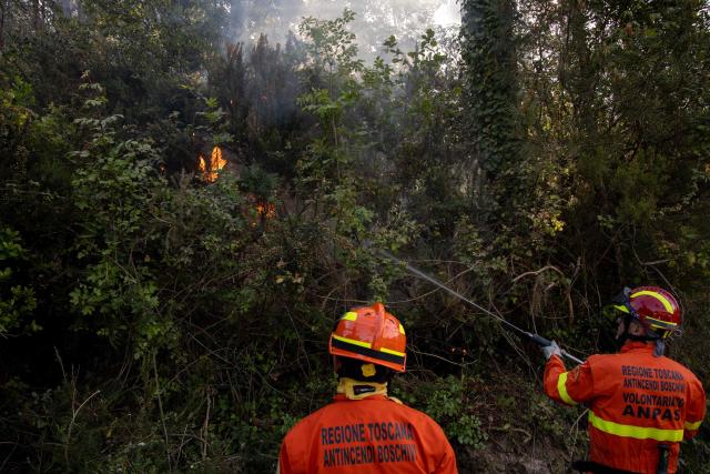 ANPAS Volunteer fighters extinguish a spot fire on the edges of a wildfire in Faeta mount forest near Pisa province in Santa Maria del Giudice on May 1, 2026. Italian authorities evacuated some 3,500 people in its famed Tuscany region on May 1, 2026 as they try to tame a wildfire that has been raging for more than 24 hours. Over 800 hectares (nearly 2,000 acres) have been ravaged by the fire in the mountains between the historic cities of Lucca and Pisa. (Photo by Federico SCOPPA / AFP)