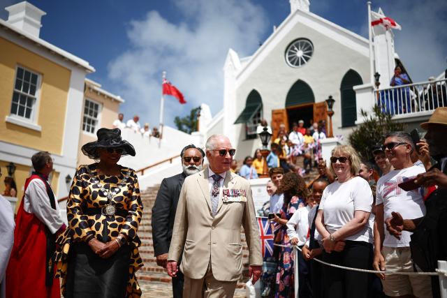 Britain's King Charles III greets members of the public as he departs St Peter’s Church during a ceremonial welcome at King's Square in St. George's, Bermuda, on May 1, 2026. Also pictured, Mayor of St. George Quinell Francis (L). King Charles III is in Bermuda for his first visit to a British Overseas Territory as Sovereign. (Photo by HENRY NICHOLLS / POOL / AFP)