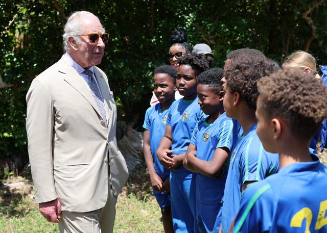 Britain's King Charles III speaks with students during a visit to a ‘Living Classroom’ on Trunk Island on May 1, 2026 in Hamilton, Bermuda. King Charles III is in Bermuda for his first visit to a British Overseas Territory as Sovereign. (Photo by Chris Jackson / POOL / AFP)