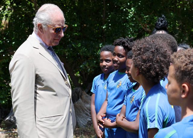 Britain's King Charles III speaks with students during a visit to a ‘Living Classroom’ on Trunk Island on May 1, 2026 in Hamilton, Bermuda. King Charles III is in Bermuda for his first visit to a British Overseas Territory as Sovereign. (Photo by Chris Jackson / POOL / AFP)
