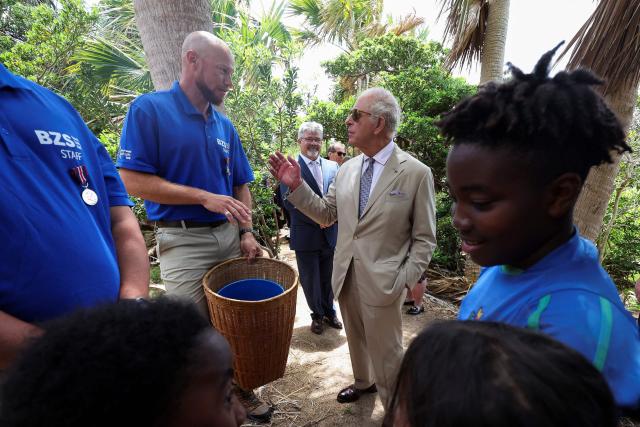 Britain's King Charles talks with Bermuda Zoological Society (BZS) staff as he visits Trunk Island to speak to students at a "Living classroom", in Hamilton, Bermuda on May 1, 2026. King Charles III is in Bermuda for his first visit to a British Overseas Territory as Sovereign. (Photo by Suzanne Plunkett / POOL / AFP)